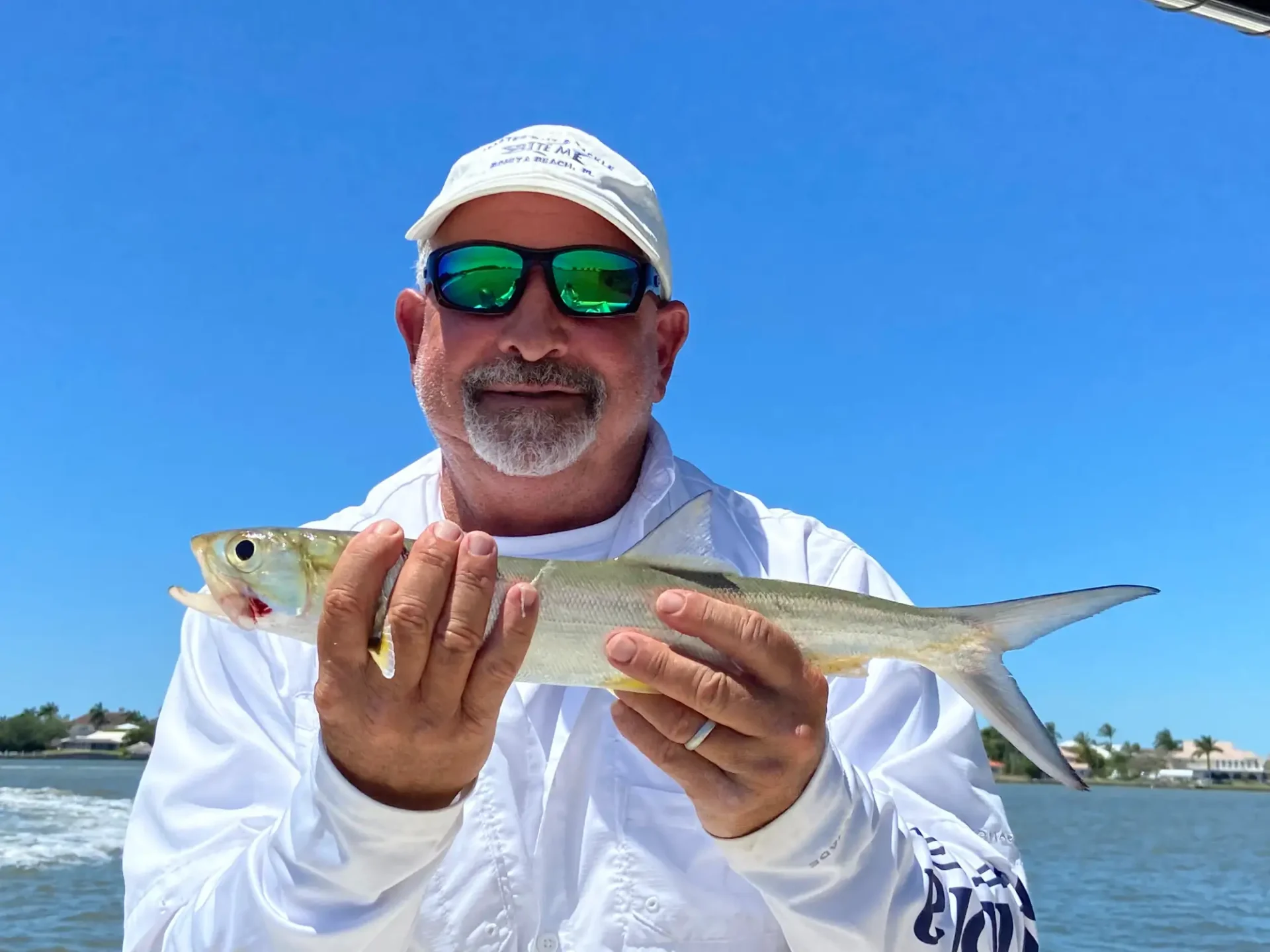 A man holding a long type of fish