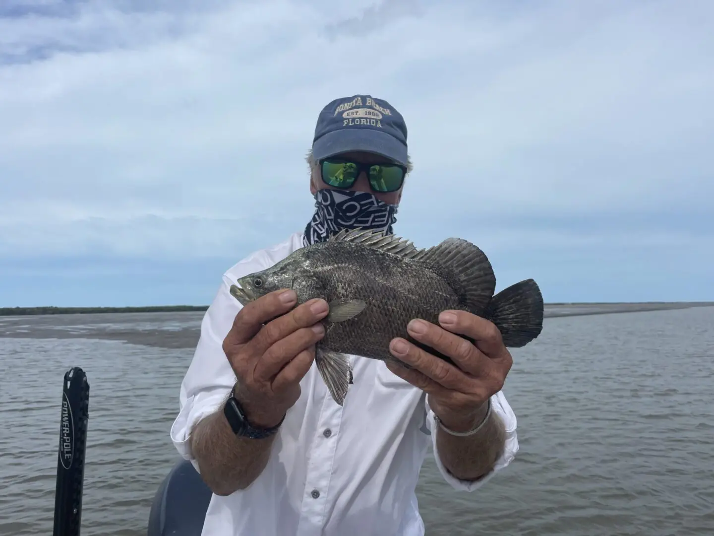 A man holding a small fish