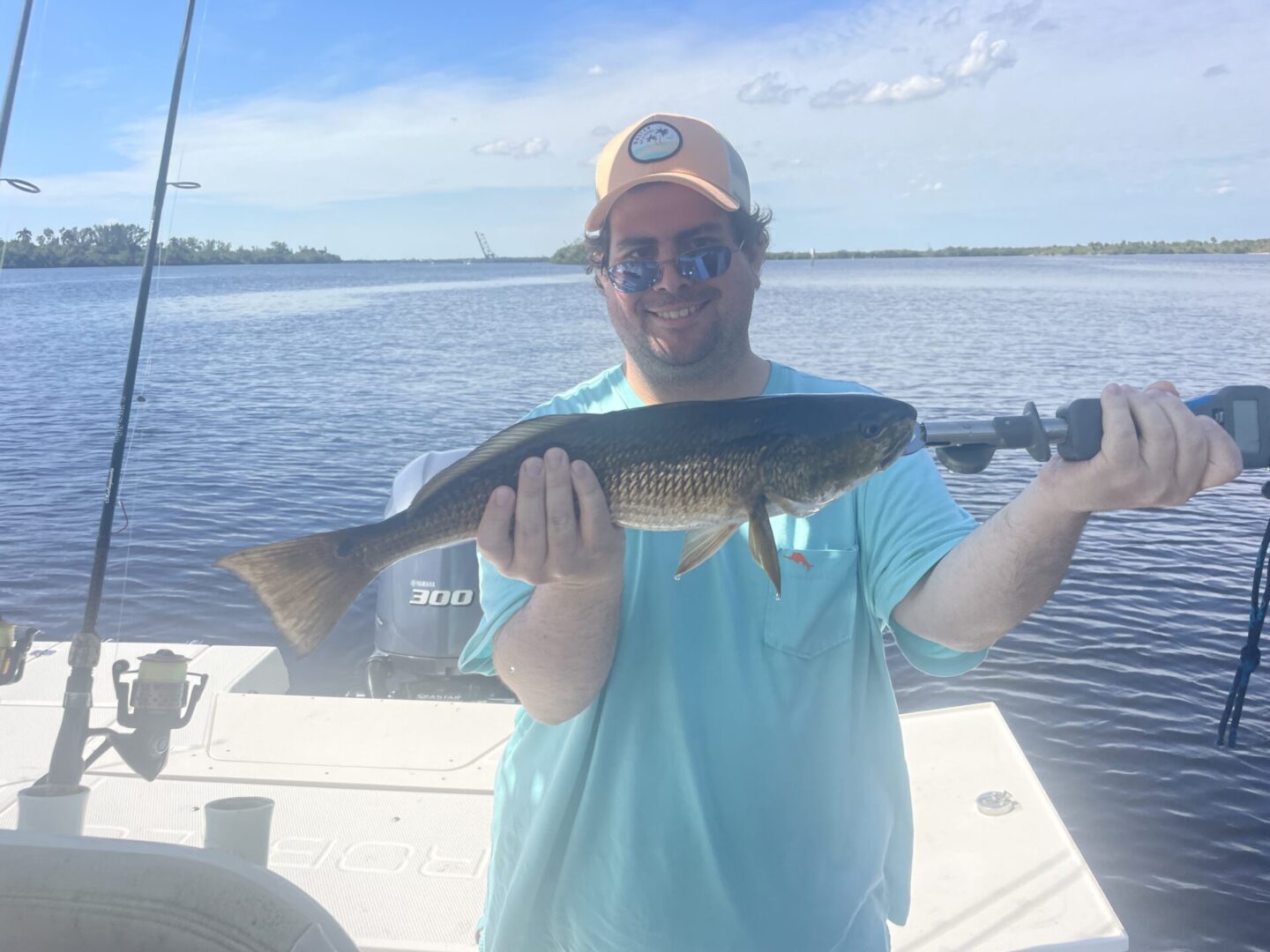 a man in sky blue t shirt with a fish